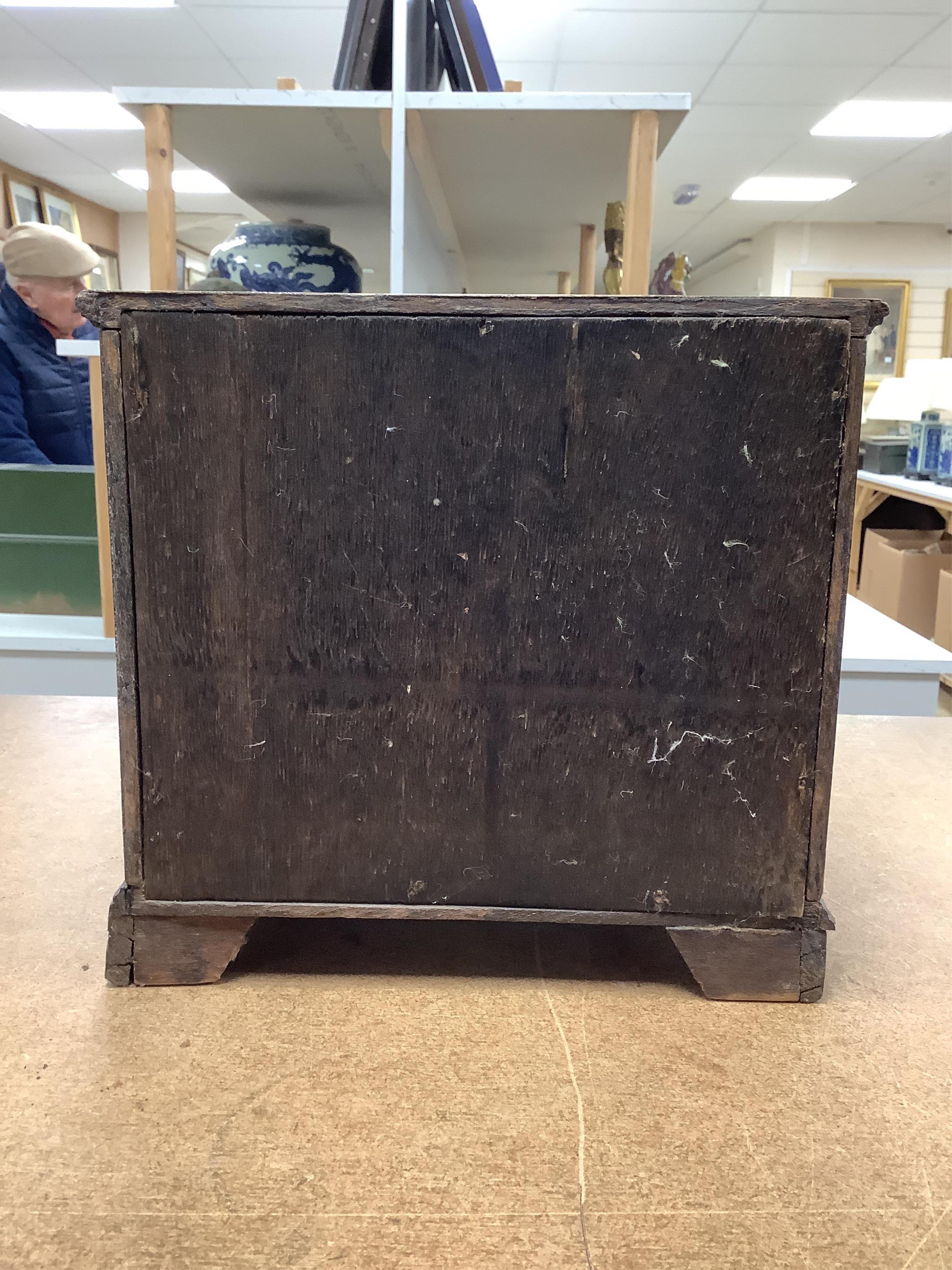 A miniature three long and two short inlaid chest of drawers, 21.5cm high x 23.5cm wide. Condition - poor to fair